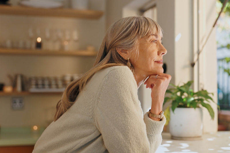 woman staring out of window